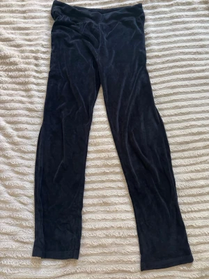 Svarta sammetsbyxor  - Mysiga svarta byxor i mjuk sammet från Cherry Koko. De har en enkel, rak passform och elastisk midja för extra komfort. Perfekta för dig som vill ha en chill look.