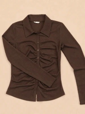 Cubus ribbad blus Ny med prislapp  - Snygg brun blus/ skjorta med ribbad struktur och rynkade detaljer längs knappraden framtill. Skjortan har klassisk krage, långa ärmar och en figurnära passform. Perfekt för dig som vill ha en trendig och bekväm look.