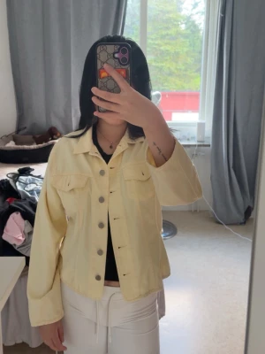 Ljusgul jeansjacka  - Jättefin ljusgul jeansjacka med klassisk krage, Jackan har en avslappnad passform och långa ärmar, perfekt för att lyfta din outfit med en färgklick.