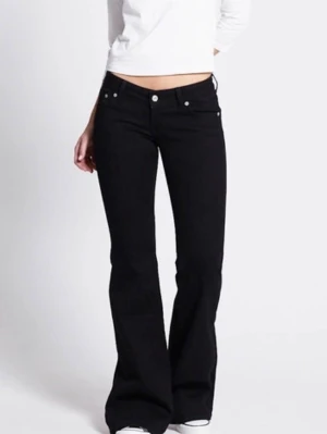 Svarta bootcut jeans med låg midja - Snygga svarta jeans med bootcut passform och låg midja. Klassisk femficksmodell med silverfärgade knappar och dragkedja. Perfekta för en trendig och avslappnad stil. Tillverkade i stretchigt denimtyg för extra komfort. Säljer då de är lite tajta på mig, jag är 165 och de är långa på mig, lite slitna längst ner ibak