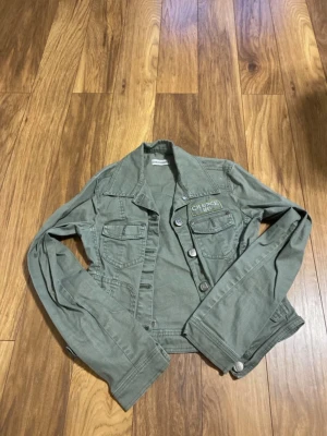 Olivgrön jeansjacka - Jättecool olivgrön jeansjacka, med fickor och andra detaljer. 