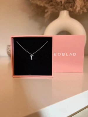 Silverhalsband med ett T från Edblad - Säljer ett fint silver halsband ifrån Edblad med ett hängande T 