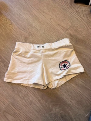 Vita shorts från Converse - Säljer ett par vita shorts från Converse med klassisk logga på ena benet. One size! Passar XS/S!