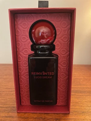 Lucid Dream extrait de Parfum  - Gorgeous Lucid Dream from Reinvented Perfumes, Extrait de Parfum 75 ml beautiful bottle with red marble cap.   Topnotes: Saffron, raspberry & plum Middle notes: Saffron, Rose & white flowers Base notes: Oud, Patchouli & Sandalwood  There is a digital receipt, I bought it online.