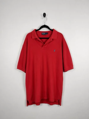 Vintage Polo Ralph Lauren Piké XL Röd Classic Relaxed Fit Blå Polo Pony 90s Y2K HerrVintage Polo Ralph Lauren Piké XL Röd Classic Relaxed Fit Blå Polo Pony 90s Y2K Herr - • Storlek: XL • Färg: Röd  • Passform: Classic Fit  • Krage: Klassisk pikékrage • Material: 100% bomull  Skick: Plagget är i väldigt fint skick. Eventuella anmärkningar anges alltid tydligt i beskrivningen och visas på bilderna.  Nypris: Cirka 1 500 kr.  📦 Skickas snabbt och packas omsorgsfullt. 💬 Hör gärna av dig om du har frågor eller vill se fler bilder. 🤝 Samfrakt erbjuds vid köp av flera plagg – kika gärna in mina andra annonser!• Storlek: XL • Färg: Röd  • Passform: Classic Fit  • Krage: K
