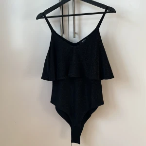 Glittrig body - Superfin glittrig body från Gina Tricot, endast använd en gång så i fint skick! Köparen står för frakten! ✨