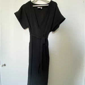 Svart Midi Klänning Bubbleroom - Svart midiklänning med band i midjan inköpt från Bubbleroom, enbart använd 1 gång.
