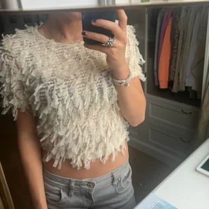 Zara toppar - Fin beige topp med fjäder liknande detaljer!!! Köparen står för frakten. Säljer pågrund av att den ej kommer till användning❤️ . Pris kan diskuteras! Köpt för 399. Passar perfekt till lågsinnade jeans!