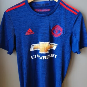 Manchester United fotbolls t-shirt. - United t-shirt i gott skick. Knappt använd. Borta ställ säsongen 16/17.   Inget tryck på ryggen.