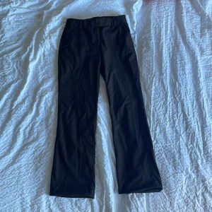 Kostymbyxor - midwaist bootcut  - Brunrandiga kostymbyxor. Sitter midwaist/lågmidjat med bootcut. 