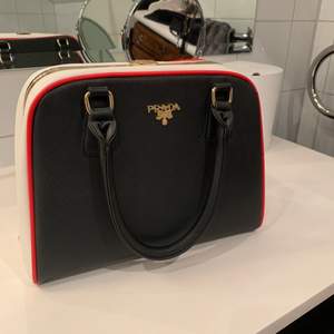  Säljer min väska❤️ Köpt i Italien och använd en gång🥰 Väskan är svart men har röda, vita och guldiga detaljer. Väskan har även med ett axelbanden så man kan använda den på olika sätt🥰