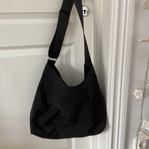 Svart väska - Svart väska med tjocka band som är justerbara! Måtten är 38 x 33 cm. Den är i bra skick! (Frakt: blå påse L 79kr)