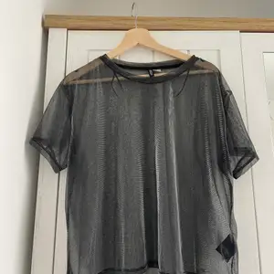 see-through top in black from H&M. shimmer allover.