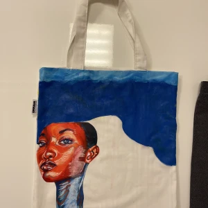 Designad tygväska  - Väskan är helt ny och i bra skick. Den var helvit från början men jag gjorde en snygg design på den. Den har mycket utrymme.