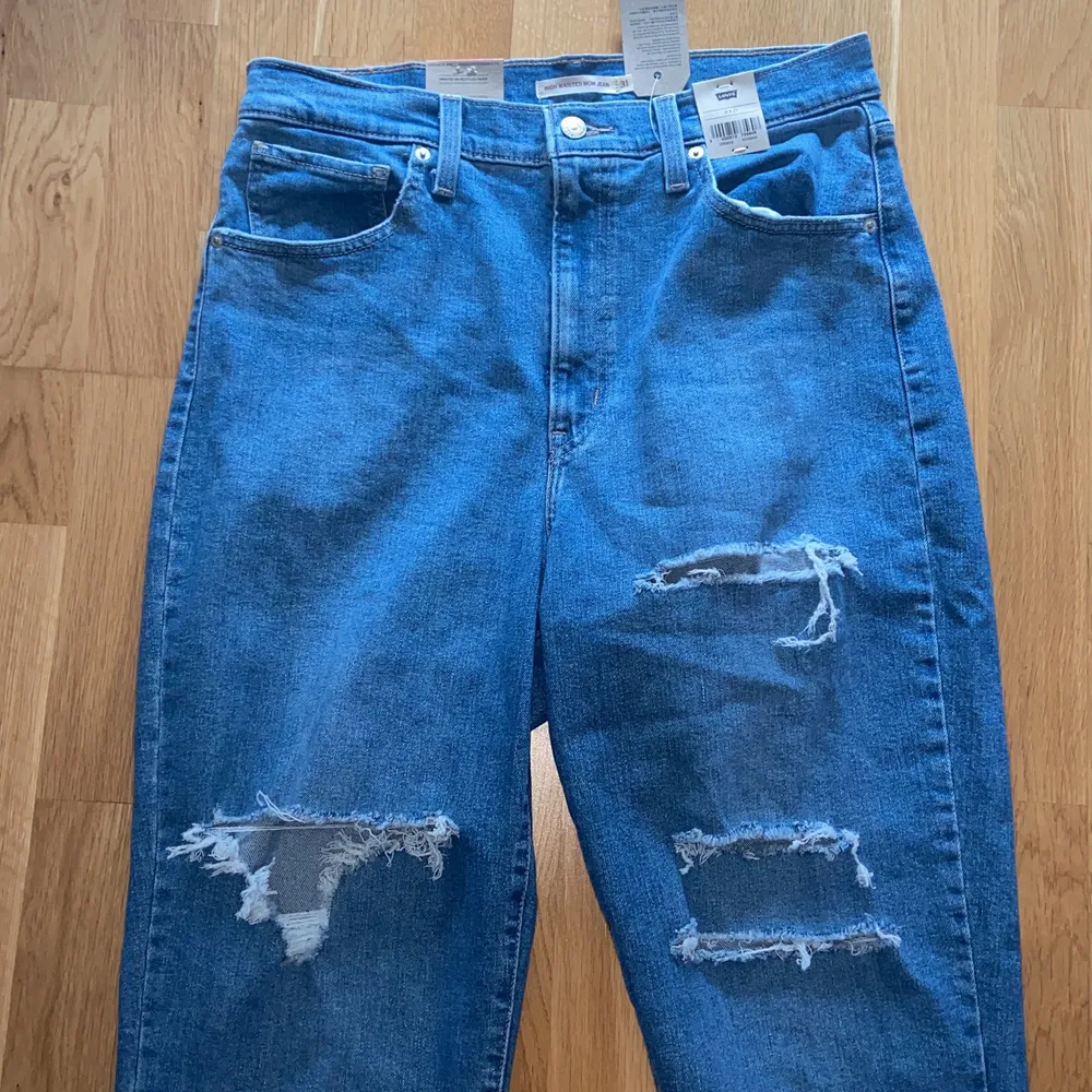 Helt nye blå Levi’s mom jeans. De er aldrig brugt, da de desværre var for store til mig.    Str. W31 L27  Nypris: 579 DKK / 802 SEK  Skriv endelig for flere billeder eller ved spørgsmål☺️. Jeans & Byxor.