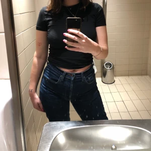 Tommy Hilfiger Jeans - Mörkblåa Tommy Hilfiger jeans. Stl 28/32.Köptes i Barcelona på Humana. Det är en slits längst ner på byxkanten, bild 3! Tyvärr en liten slitning på bild 2 vid midjan som fanns när de köptes! Gissar att det är från en prislapp, men har ej repats upp eller blivit större efter användning i 1 år.