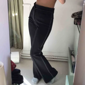  - Bootcut kostymbyxor, skitsnygga med pressveck, svarta med trendiga vita sömmar.