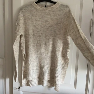 Stickad tröja - Beige stickad tröja med slits på sidorna