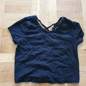 Croptop Black strl 34 - Svart croptop med öppen rygg/spets detaljer i ryggen. FRAKT INGÅR EJ