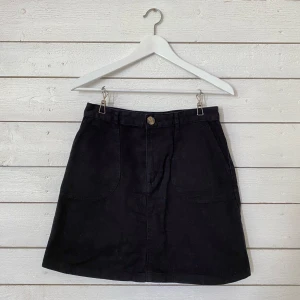 Svart jeanskjol, Monki - Svart jeanskjol som knäpps i fram med dragkedja och knapp. Använd men i fint skick. Passar mig som vanligtvis har storlek S men kan vara svår att få över höfterna om man har lite bredare höfter. Frakt tillkommer (42kr). 