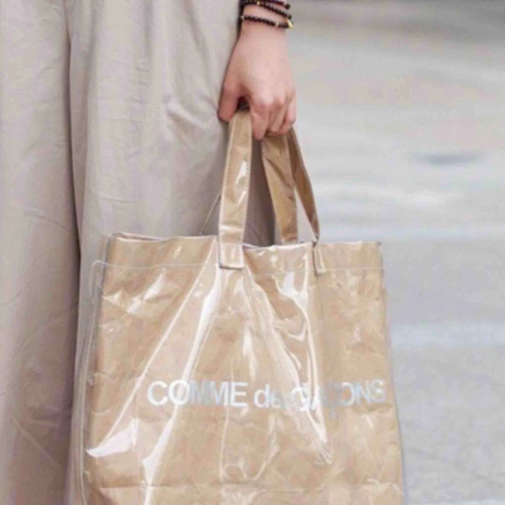 Comme de Garcons paper/plastic tote bag. Ej kommit till användning så inga fel på väskan! . Väskor.