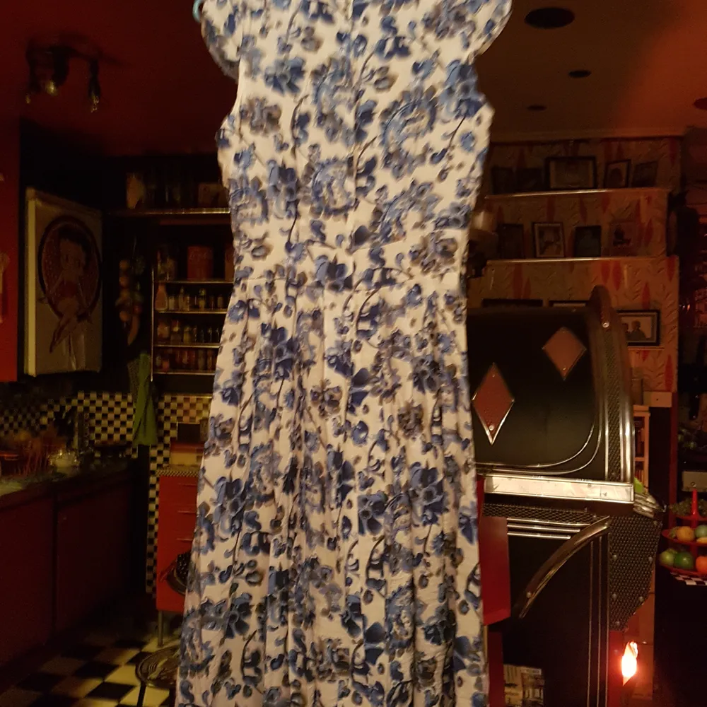 En fin klänning beige /vitmed blåa blommor på i storlek S. Frakt 66 kr spårbart. Klänningar.