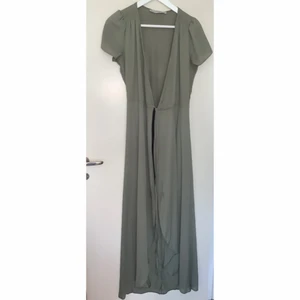 Balklänning - Jättefin khakifärgade balklänning med knytning. Har en innerkjol så att den inte är genomskinlig. Köpt från ASOS hösten 2018. Använd 1 gång så i jättefint skick. Det står strl 8 vilket motsvarar strl 34. Frakt ingår i priset.