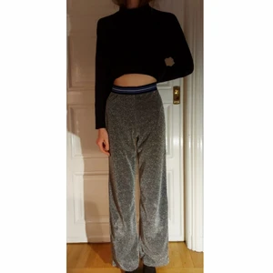 Bikbok glitter byxor strl 36 - Silver glittriga byxor med färgad resår och lätt utsvängda nedantill. Har ett svart tunt innerfoder och är super bekväma att ha på. Är sann till storleken men blivit något slappa i passformen på mig.
