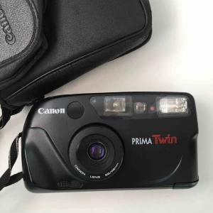  - Säljer en Canon Prima Twin från min samling. Analog kompaktkamera, använder 35 mm film. Blixt finns, objektiv med 28-48 mm brännvidd. Underbar kamera! Lätt att handskas med.