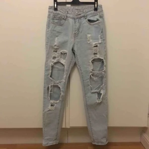  - Ljusblå jeans med hål över stora partier av benen, skitsnygga!! Säljer då de tyvärr inte kommit till användning på sista tiden. Frakt på 69kr tillkommer.