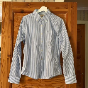 Skjorta - Hollister skjorta med blåa och vita ränder. Bra skick. Frakt tillkommer 