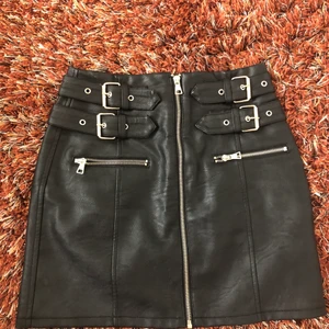 Skinnkjol - Svart skinnkjol med silvriga spännen.