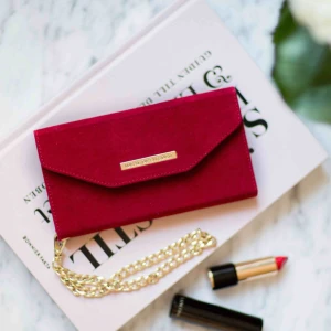  - Mayfair Clutch Red Velvet för iPhone X/XS. Tre kortfack + sedelficka. Guldfärgad handledskedja. Svart mobilskal medföljer, alla iDeal of Sweden’s ”Fashion cases” är magnetiskt kompatibla med denna! HELT NY!