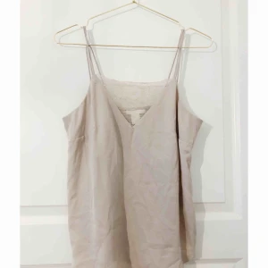  - Tunt beiget linne med spaghettiband och spets upptill. Använt 2 ggr. 