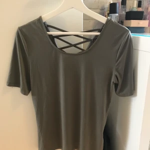 Mörkgrön t-shirt - En mörkgrön t-shirt som jag inte längre använder. Öppen till viss del i ryggen och är i bra skick. 50kr plus frakt, kontakta mig för intresse<3