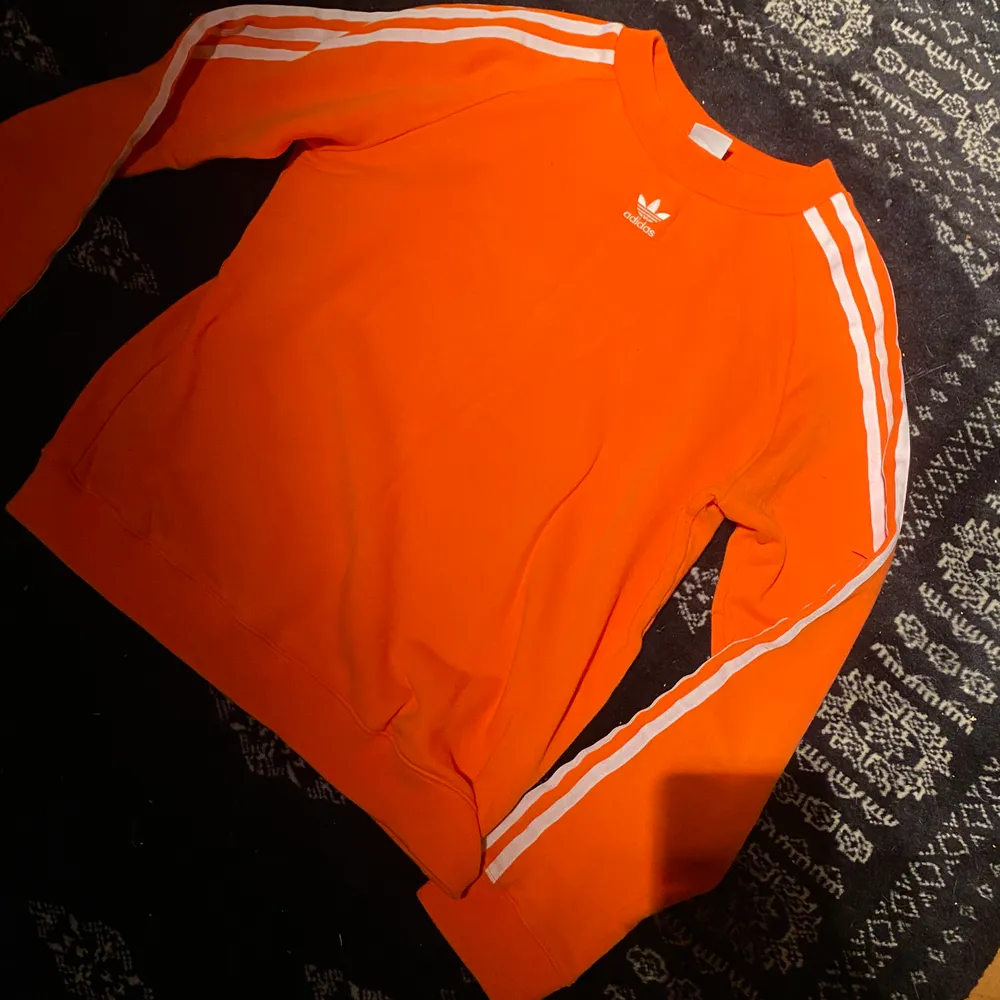 Skitsnygg orange adidas tröja, köpt från jd sports. Använd fåtal gånger.. Hoodies.