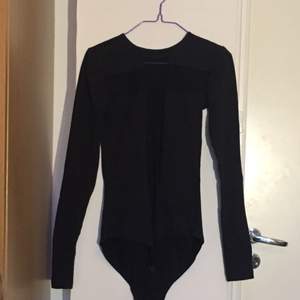 Bodysuit with a transparent fabric cross in the front, passed sixes S-M