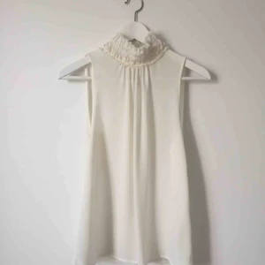  - Vit top från H&M med polokrage. Använd endast en gång. 