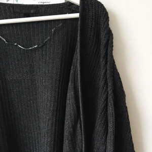  - Mörkgrå stickad lång kofta i lite overzise. Från BIK BOK. 