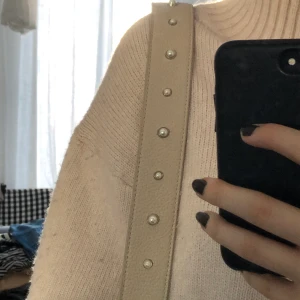 Axelband - Beige axelband till väska. Går att sätta på andra väskor. Är ganska kort o passar en ”shoulder bag”. Säljaren står för frakt. Står ej för postnords slarv🤎