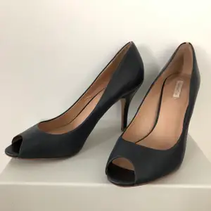 Dark blue with nude strip on the heel. Open toe and very comfortable. Looks great on any occasion 