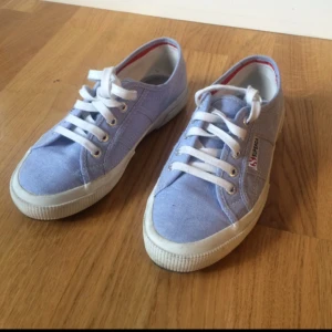 - Sneakers från Superga i ljusblått. Använda endast ett par gånger. Jag har normalt sett storlek 36-37, dessa är alltså rätt stora i storleken. Originalpris 750 kr.