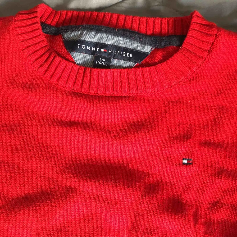 Som ny, röd stickad Tommy Hilfiger tröja. Stl ungdom 16/18 är som stl XS Köparen står för porto. Stickat.