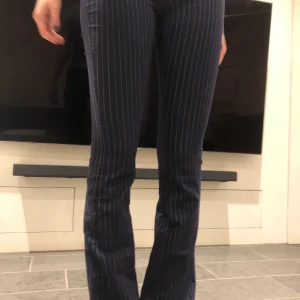 Mango utsvängda randiga  - Super sköna snygga utsvängda randiga byxor! Marinblåa med vita smala sträck! Töjbara så skulle säga 32-36!!🤍💙