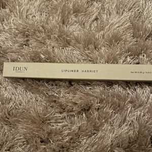 IDUN Minerals Lipliner Harriet - Snygg läppenna från IDUN Minerals i nyansen Harriet. Pennan kommer i en stilren beige förpackning och är vegansk. Perfekt för att definiera och forma läpparna med precision. Innehåller 0,35 g och är tillverkad i Tyskland.