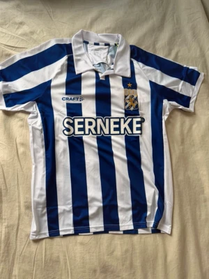 IFK Göteborg matchtröja  - Säljer en officiell IFK Göteborg matchtröja från Craft i storlek M. Tröjan har klassiska blå och vita vertikala ränder, broderat klubbmärke med gul stjärna och vit krage. Materialet är lätt polyester som andas och passar perfekt för fotboll.
