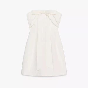 Vit axelbandslös klänning med rosett - Superfin vit axelbandslös kortklänning med en stor dekorativ rosett framtill. Den är slutsåld på Zara. Nypris 599kr!! 