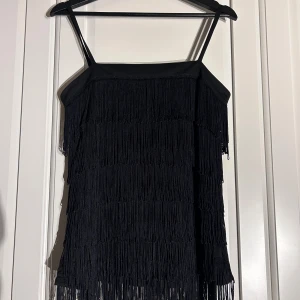 Fringe top - Bought at a flea market and I've only worn it once. Fits well for a "flapper girl" costume! Size is S, but fits a size M just fine. Some of the threads/tassels may have broken, but it's not visible from the outside.