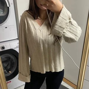 Stickad tröja - En beige stickad tröja i storleken S