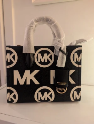 Svart handväska från Michael Kors - Liten handväska från Michael Kors. Aldrig använd, finns lappar samt papper kvar i den. Såklart äkta. 